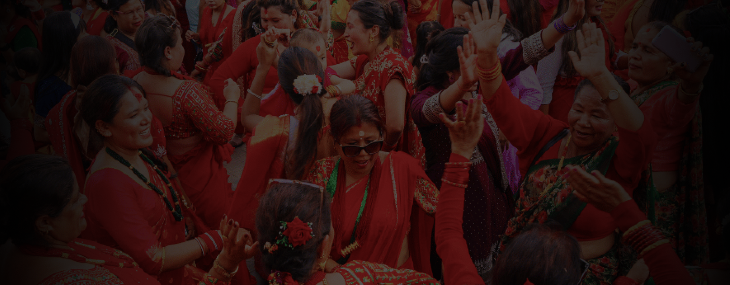 Women joyfully celebrating Teej 2082 B.S. with traditional dance and attire.
